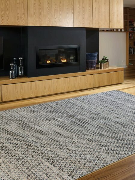 Braid Hive natural wool in denim colour flatweave rug lifestyle image in lounge room