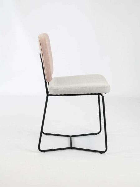 Candy dinign chair in two tone fabric in pink and natural with black legs side view