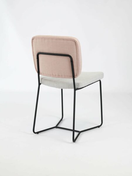 Candy dinign chair in two tone fabric in pink and natural with black legs back view