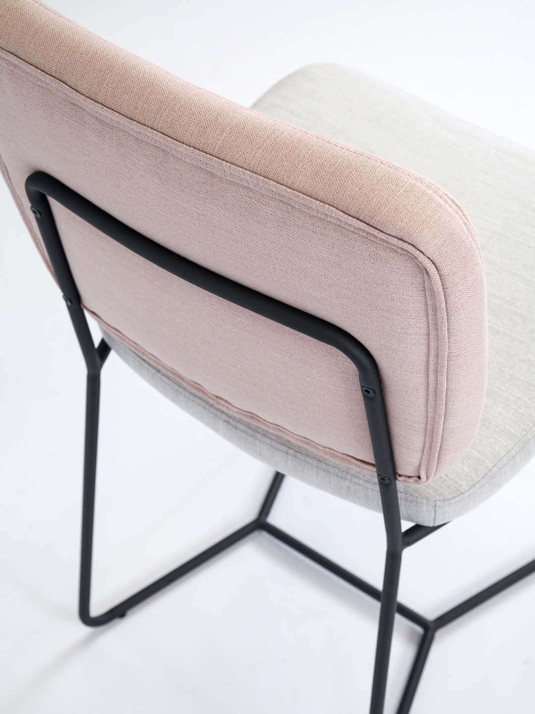 Candy dinign chair in two tone fabric in pink and natural with black legs back detail of chair