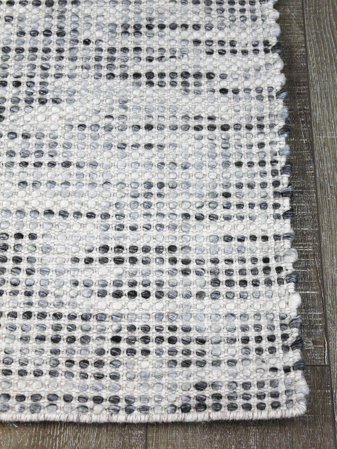 Kober flatweave pure 100% wool rug mist grey corner on floorboards