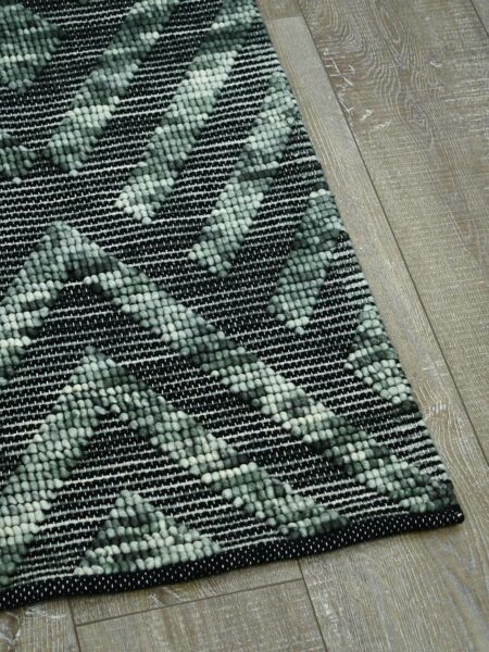 Zamora Forest handwoven flatweave rug in green and black - corner image