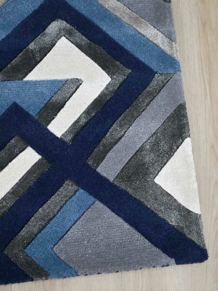 Element Bluejay handtufted wool and artsilk rug with geometric pattern in blue and grey tones corner of rug