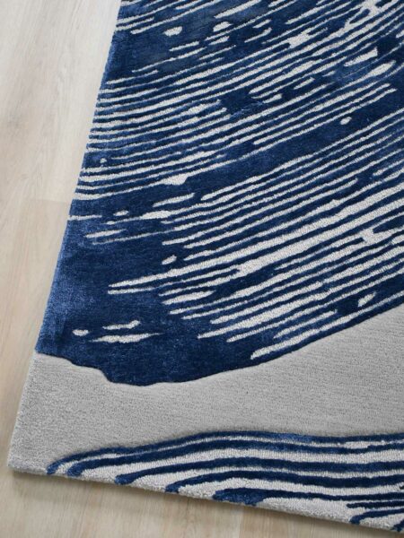 Niagara Denim organic lines textured rug in navy blue and grey corner of rug
