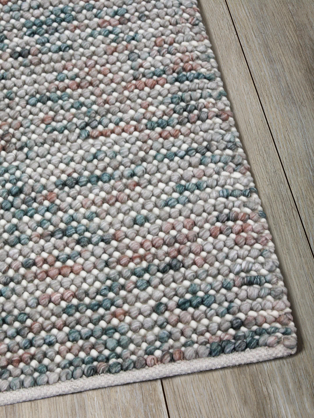 Magic Oasis multicoloured textured rug handwoven in wool - corner image