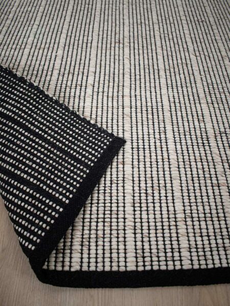 Cable beige sand handwoven rug by the rug collection insitu back