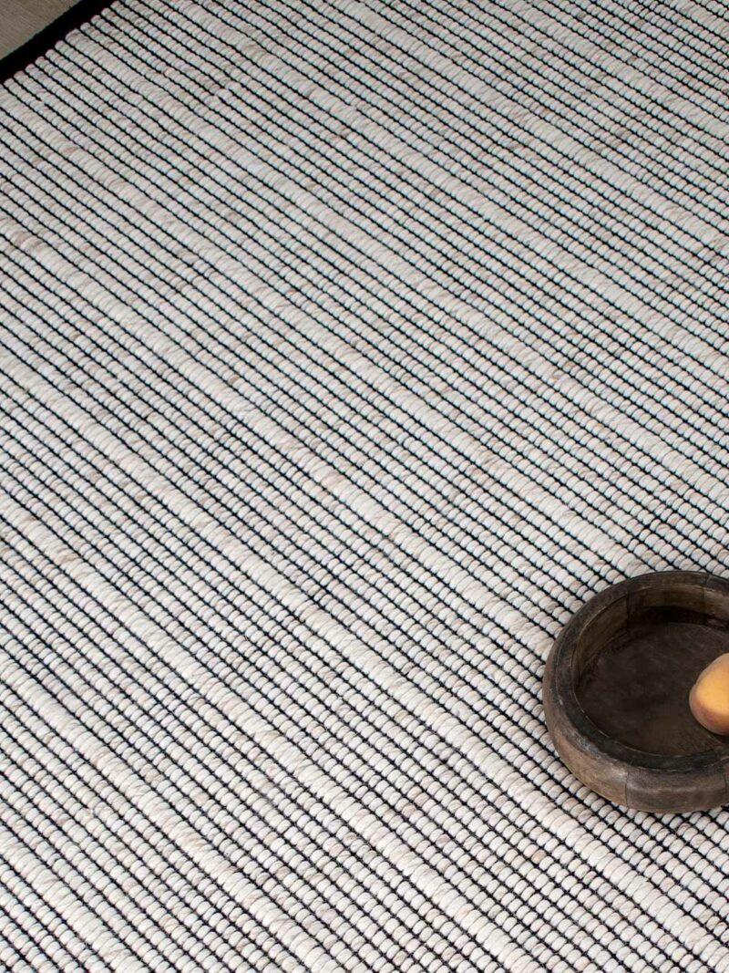 Cable Rug beige sand handwoven rug by the rug collection insitu texture